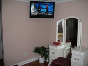 32" Flat Screen Installation on articulating wall mount in corner of Master Bedroom