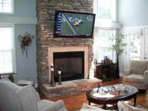 60" Sony LED TV Installed on stone wall above fireplace. 