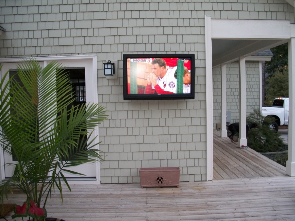 Back patio custom fitted with Sunbrite Outdoor Weatherproof TV & Rockustics Flower Planter Speaker System