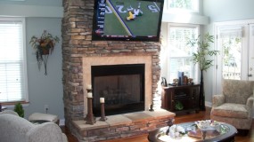 60" Sony LED TV Installed on stone wall above fireplace.